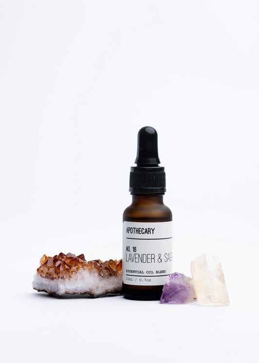 a bottle of lavender and sea salt next to a rock