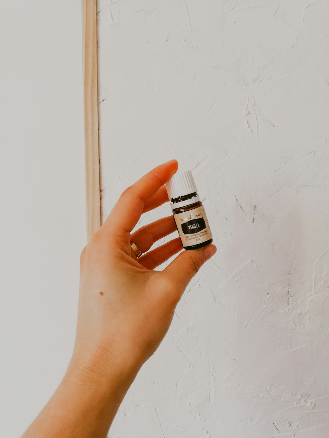 person holding white and black plastic bottle