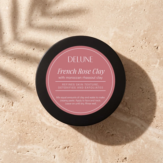 Delune French Rose Clay Mask jar from above on warm travertine in soft window light