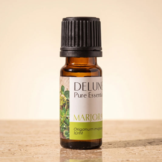 Delune Marjoram Pure Essential Oil, 10ml amber glass bottle on warm travertine stone
