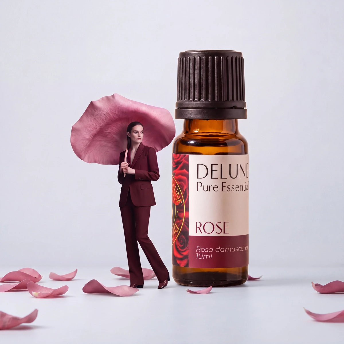 Nature: a woman under a giant rose petal beside a giant Delune Rose Pure Essential Oil